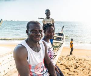  James with his partner and their son on the beach.