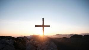 A photo of a cross on a hill