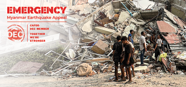 Survivors stand in the remains of the destruction of the earthquake in Myanmar. Red font on the left side reads: Emergency Myanmar Earthquake appeal. DEC logo. CAFOD DEC member. Together we're stronger. 