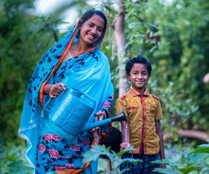Shukla and her son in their garden in Bangladesh