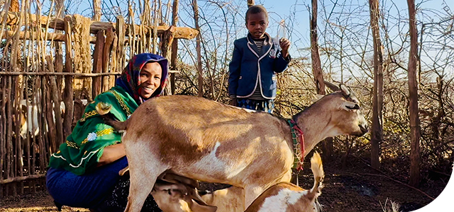 Ware with her son and their goats