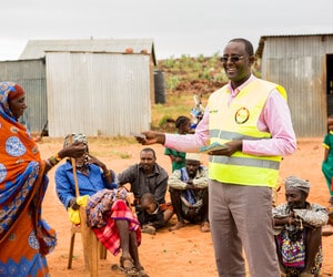 Isacko, director of Caritas Marsabit giving out food vouchers
