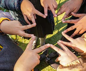 CAFOD volunteers making a star with their hands